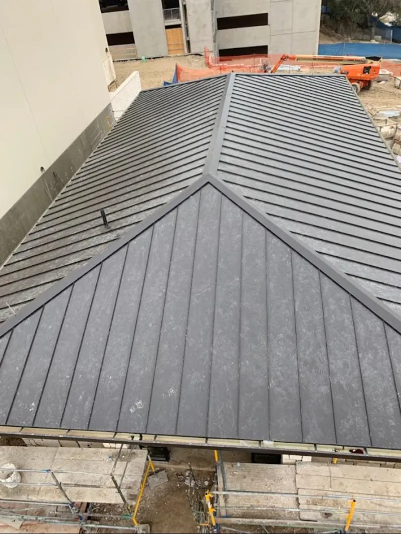 Commercial metal roof construction with crane equipment in North Vernon